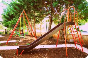 a playground with a slide in a park at Residence Martina in Marina di Camerota