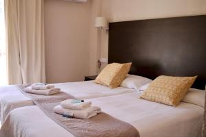 Postel nebo postele na pokoji v ubytování Hostal Jakiton