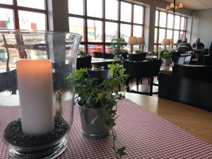 a candle sitting on a table in a restaurant at Jennys Hotell och Restaurang in Arvika