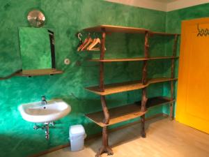 a bathroom with a wooden shelf next to a sink at Schiff Bihlerdorf - Hostel in Bihlerdorf