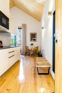 a kitchen and living room with a table and chairs at Formosa 178 by Guestify in Porto