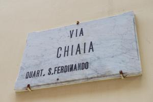 a sign on the side of a wall at Chiaia 197 Deluxe Residence in Naples