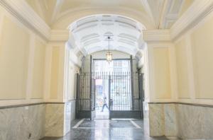 an ornate hallway with a door in a building at Chiaia 197 Deluxe Residence in Naples