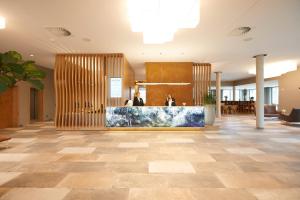 a lobby with a reception desk in a building at Hotel Rittergut Stoermede in Geseke