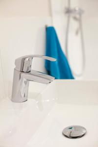 a bathroom sink with a chrome water faucet at Kuwadro Guesthouse Centrum in Amsterdam