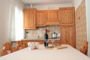 a bottle of wine sitting on a table in a kitchen at Albergo diffuso Valcellina e Val Vajont in Claut in Claut