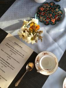 a table with a menu and a plate and a spoon at Pier House in Doolin