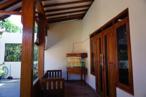a hallway of a house with a door and a window at Jogja Classic Homestay Syariah in Yogyakarta