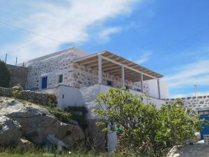 a building on top of a hill with a rock at Amazing View Dream House in Chora Folegandros