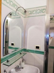 a bathroom with a mirror and a sink at Amalfitani Salerno Centro in Salerno