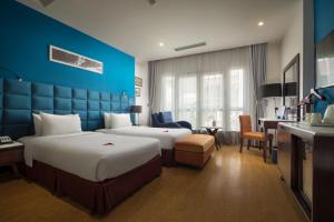 Postel nebo postele na pokoji v ubytování Hanoi Brilliant Hotel & Spa