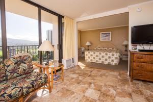 a hotel room with a bed and a television at Sweetwater at Waikiki in Honolulu