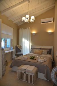 a bedroom with a large bed and a chair at Meni Sweet Luxury Home in Volos
