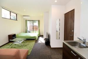 a bathroom with a sink and a bed in a room at Fuji scenic house 73 in Fujikawaguchiko