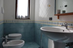 a bathroom with a sink and a toilet and a mirror at Villa delle Sirene in Ascea +26 photos