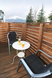 a table and two chairs on a wooden deck at Fuji scenic house 73 in Fujikawaguchiko