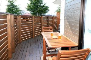 a wooden table and chairs on a deck at Fuji scenic house 73 in Fujikawaguchiko