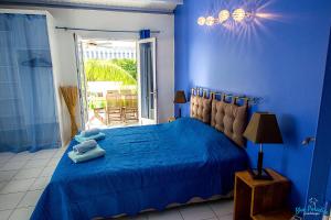 a blue bedroom with a bed with blue sheets at Blue Paradise in Le Gosier +40 photos