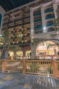 a large building with a wooden fence in front of it at Paragon Casino Resort in Marksville