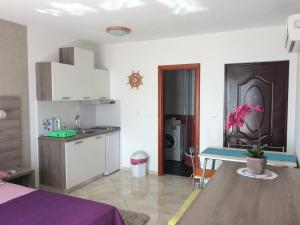 a kitchen and dining room with a table in a room at Apartments Rakuljic in Podstrana +126 photos