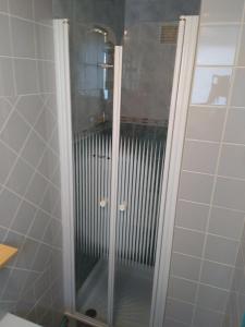 a shower with a glass door in a bathroom at FLAB' MARIN in Le Tréport
