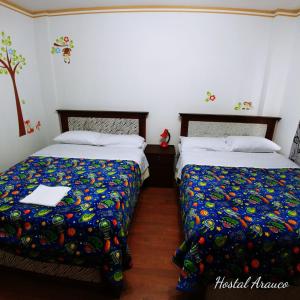 Postel nebo postele na pokoji v ubytování Hostal Arauco
