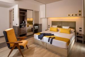 a bedroom with a king sized bed and a chair at Hotel Domidea in Rome