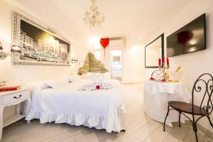 ローマにあるSuites Roma Tiburtina Eleganceの白いベッドルーム(ベッド1台、クリスマスツリー付)