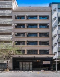 a tall building with a parking garage in front of it at Soneca Plaza Hotel in Sao Paulo