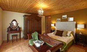 a bedroom with a bed and a wooden ceiling at Casa Samuel in Navia