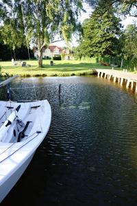 a white boat is docked in the water at Ferien in Himmelpfort in Himmelpfort