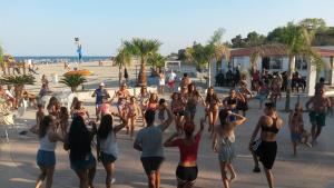 a group of people doing yoga on the beach at Attico al mare in Badolato