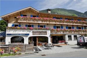 a building with flowers on the balconies of it at Le Saint Antoine in Les Houches