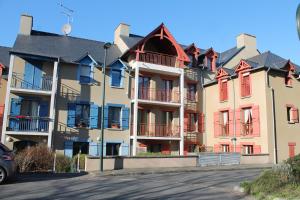 a row of apartment buildings with red balconies at Belle Brise - Cozy apartment in city center in Cancale