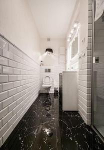 a bathroom with a sink and a toilet in it at Elegant Apartment Foksal in Warsaw