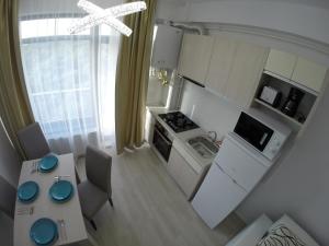 an overhead view of a kitchen with a table and chairs at Lotus nr 9 Mamaia Apartments Sea View in Mamaia