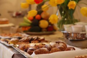 a table topped with different types of pastries on a table at Hotel Medici in Milazzo
