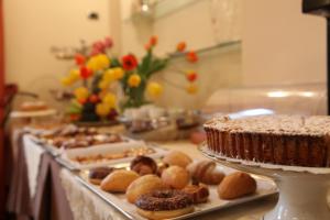 a table filled with different types of pastries and cakes at Hotel Medici in Milazzo