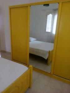 a small bedroom with a mirror and a bed at Casa Mendes in Tarrafal