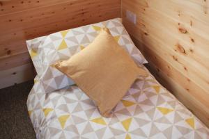 a small bed with a pillow on top of it at Howe of Torbeg in Ballater