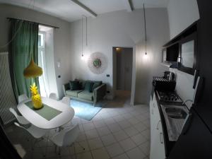 a kitchen and living room with a couch and a table at Doma 4.2 in Riccione +9 photos