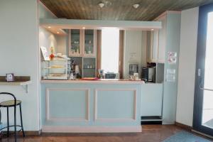 a kitchen with white cabinets and a counter top at L'incanto Di Boccadarno in Marina di Pisa