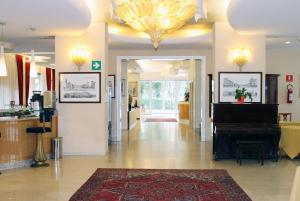 a lobby with a grand piano in a store at Hotel Albatros in Mestre
