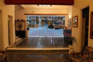 a lobby with a view of a pool at Hotel Solon in Tolo