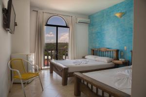 Postel nebo postele na pokoji v ubytování Hotel Anamichu Suites