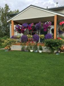 a house with lots of flowers in the front yard at Fishhook Sunrise B&B in Palmer