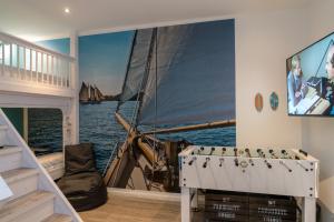 a room with a large mural of a boat at Beachhouse in Cuxhaven