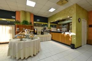 a table with plates of food on it in a restaurant at Sun Hotel in Rubiera
