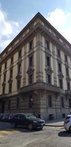 a large building with cars parked in front of it at Guest House La Grancontessa in Florence