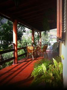 a porch with a table and chairs on it at Casa Rural Nuevitas I in Hermigua